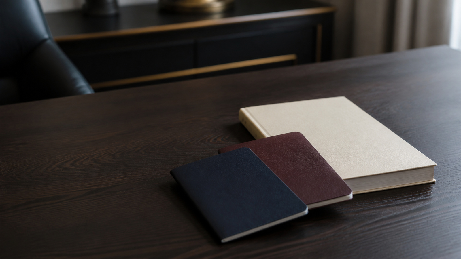 Two passports of different colours on a table beside a marriage file