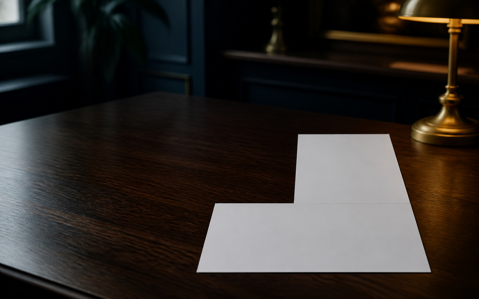 Two national tax forms lying at right angles on a dark desk